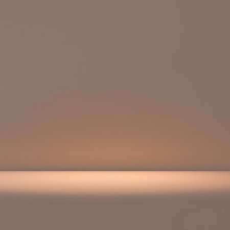 A clean, empty studio space featuring soft, warm illumination and a smooth, subtle color transition across the surface.の素材