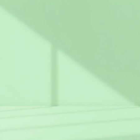 A clean and modern studio backdrop featuring soft mint green tones and subtle geometric shadow play.の素材