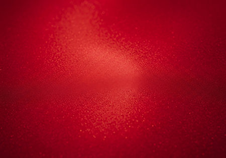 A rich red background featuring a subtle geometric mosaic texture and a soft, luminous glow in the center.の素材