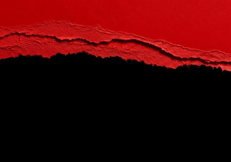 A close-up view of torn red paper revealing a stark black background, creating a dramatic abstract texture.の素材