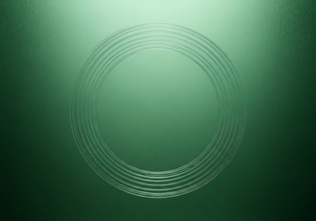 A close-up of a textured green surface with a circular pattern resembling ripples or a fingerprint.の素材
