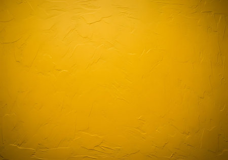 A close-up, abstract view of a textured golden yellow surface with tiny, scattered bubbles creating a unique visual pattern.の素材