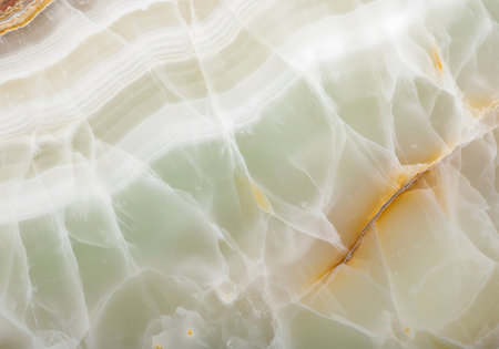 Close-up view of translucent green onyx with delicate white veining and subtle golden accents, creating a natural abstract pattern.の素材