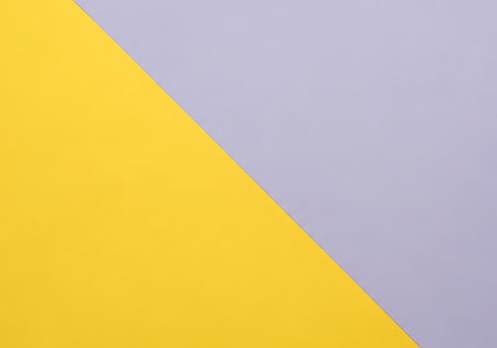 A clean, minimalist background featuring a sharp diagonal line dividing a vibrant yellow section from a muted gray area.の素材