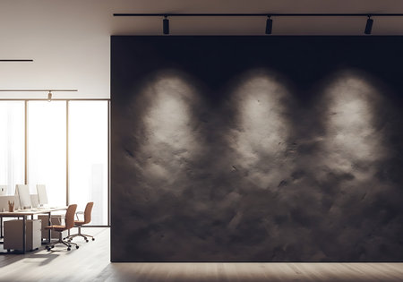 An interior view of a contemporary office with ample natural light and a striking textured wall illuminated by overhead spotlights.の素材