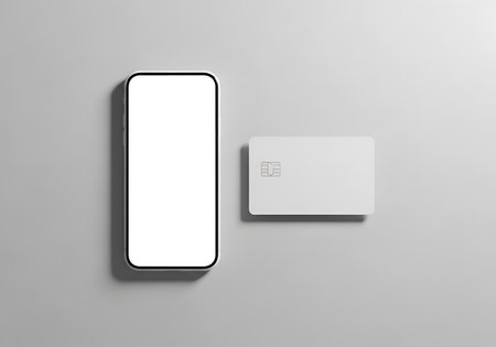 A sleek mobile device with a blank screen sits next to a contactless payment card, showcasing a minimalist digital transaction concept.の素材