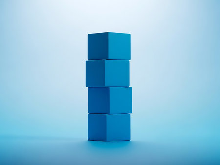 A vertical arrangement of four identical blue building blocks stacked precisely on top of each other, creating a simple tower.の素材