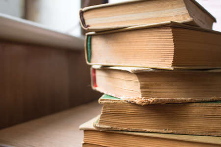 A stack of old yellowed booksの写真素材