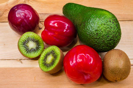 Ripe kiwi and avocado plumsの写真素材