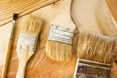 Paint brushes on a wooden surfaceの写真素材