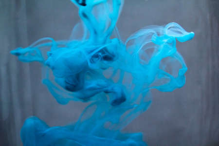 Abstract paint patterns in waterの写真素材