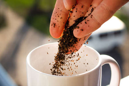 Pour tea into a mugの写真素材