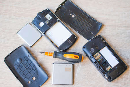 Screwdriver and disassembled smartphones