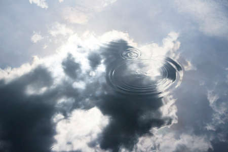 Reflection of clouds in water backgroundの写真素材