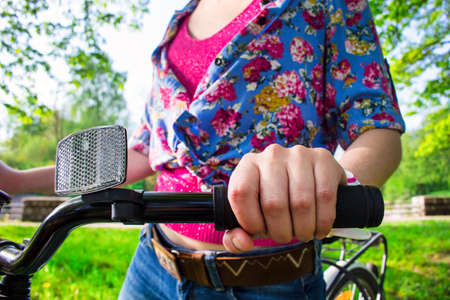 Hand of a girl on a bicycle handlebarsの写真素材