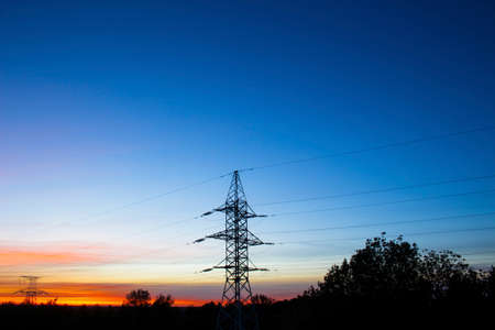 Beautiful red sunset and high-voltage linesの写真素材