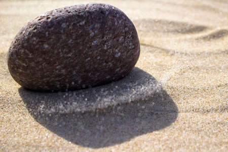 Stone falling in the sand
