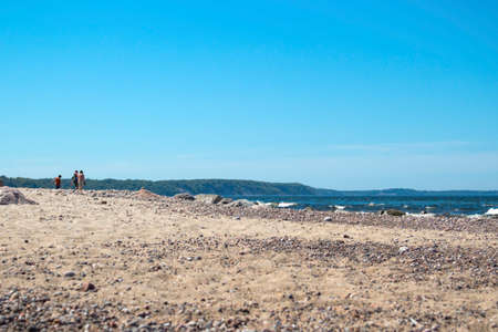 Family with a child walking on the beach
