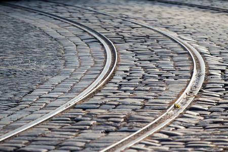 tram rails in paving stones in the middle of the roadの写真素材