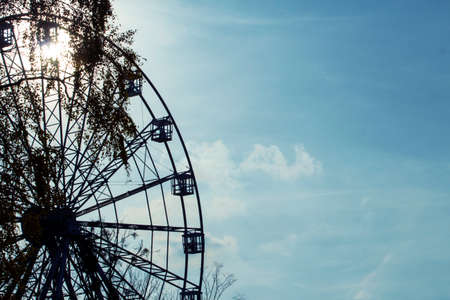 silhouette of a ferris wheel on a background of a sunny sky tonedのeditorial素材