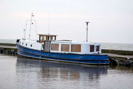 a small fishing boat by the pier