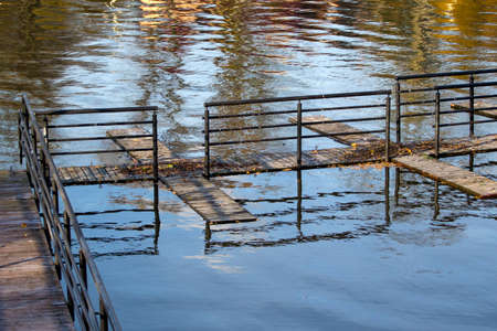 a pier for boats on the shore of the lakeの写真素材