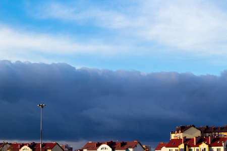 a beautiful stormy sky above the roofs of the housesのeditorial素材