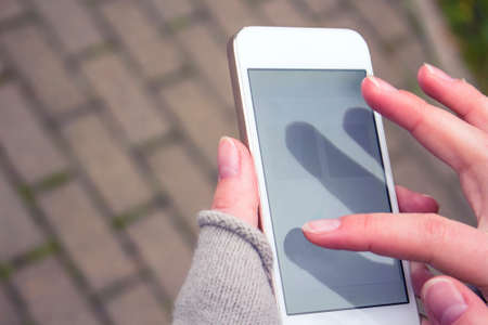 beautiful female hands with smartphone toned