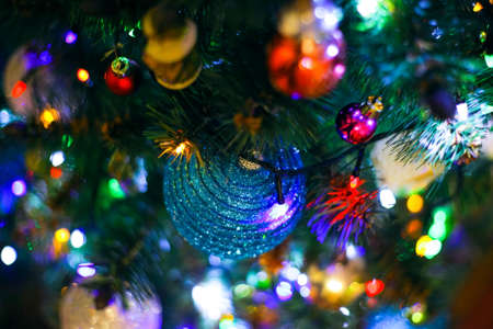 balls and garlands on the decorated home tree