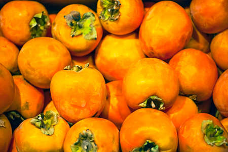 fresh persimmon on the shelf in the storeの写真素材