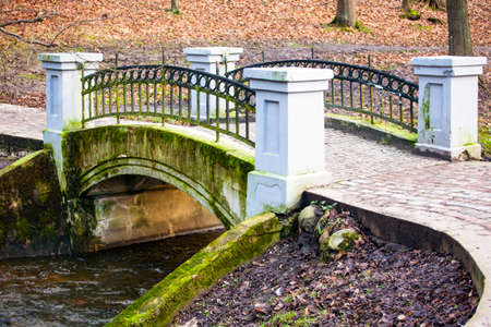 beautiful little bridge across a narrow riverの写真素材