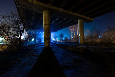 under the bridge at night, with a mysterious blue lightの写真素材