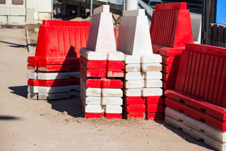 a stack of red white roadblocks