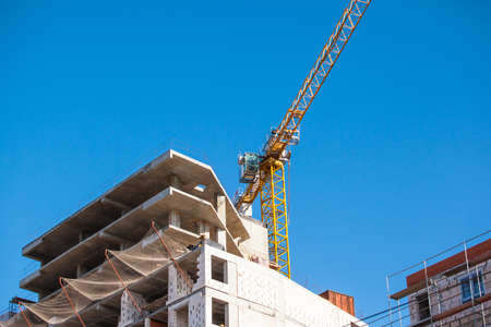 a crane near a modern building under construction
