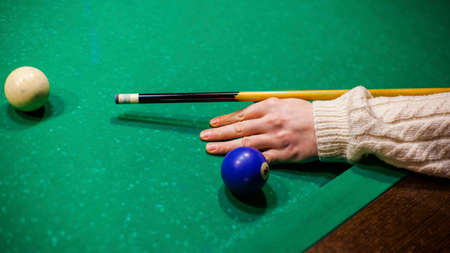 person plays billiards