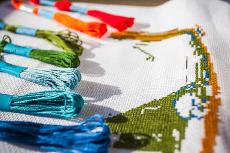 multicolored threads and cross stitchの写真素材