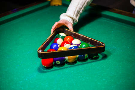 person plays billiards