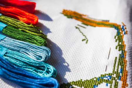 multicolored threads and cross stitchの写真素材