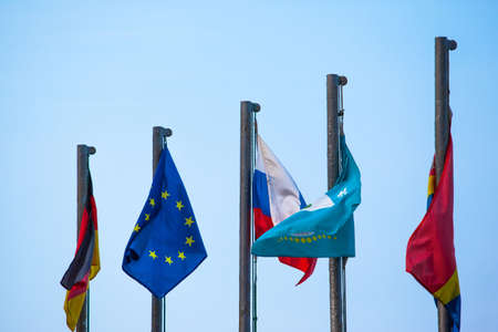 flags of the European Union and countries on the flagpole against the sky