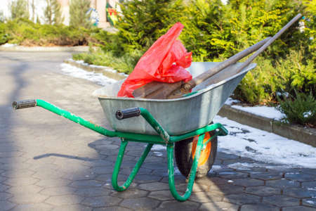 Garden tools in a cart with a shovelの写真素材