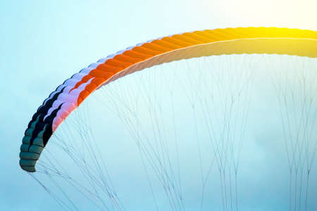 A man is flying on a paraglider in the sky, tonedの写真素材