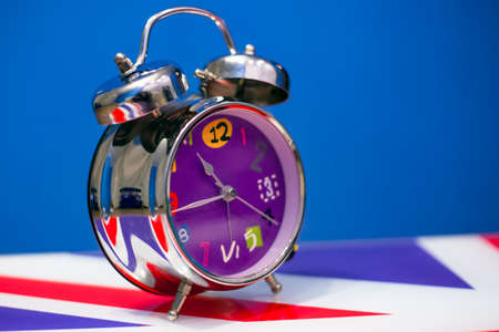 big alarm clock with bells on the table