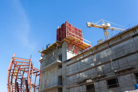 a crane near a modern building under construction