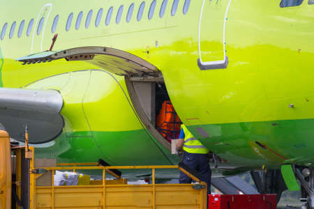 unloading of luggage from an aircraftの写真素材