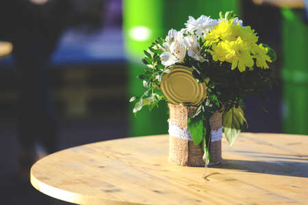 a bouquet of flowers in a pot on a table, retro tonedの写真素材