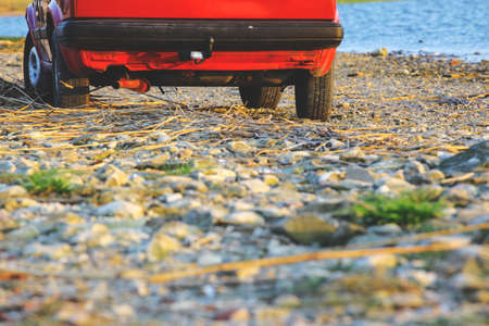 red car by the lake