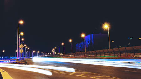 traces of car headlights on a night street, toned