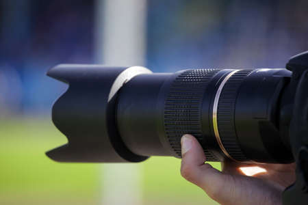 large lens in photographer's hand