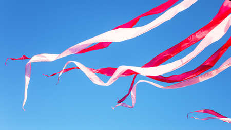 festival ribbons and flags fluttering downwindの写真素材