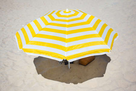 big bright beach umbrella in the sandの写真素材